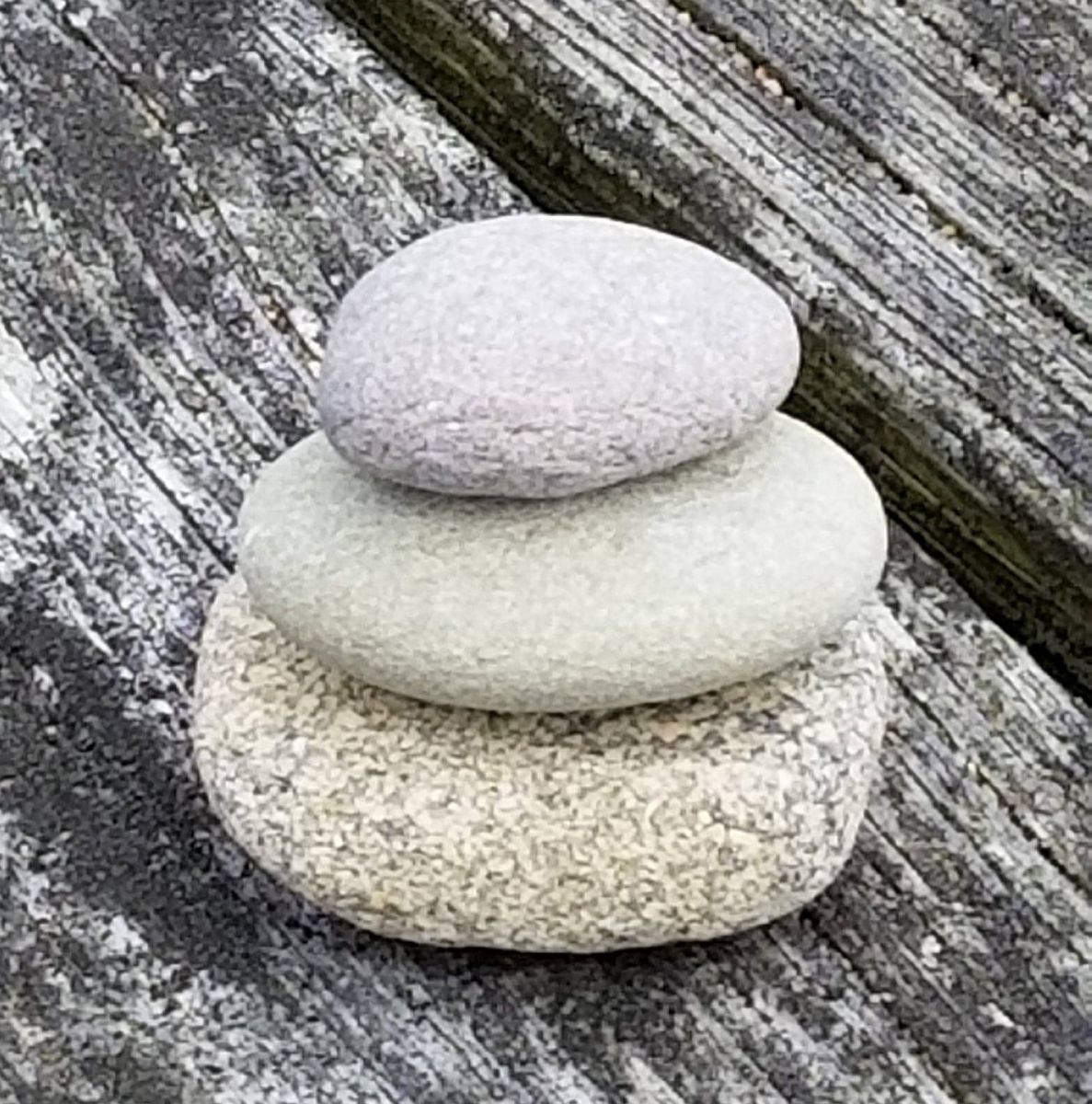 A stack of sea smoothed stones from a nearby Falmouth, Ma beach creates a relaxing focal point for meditation.